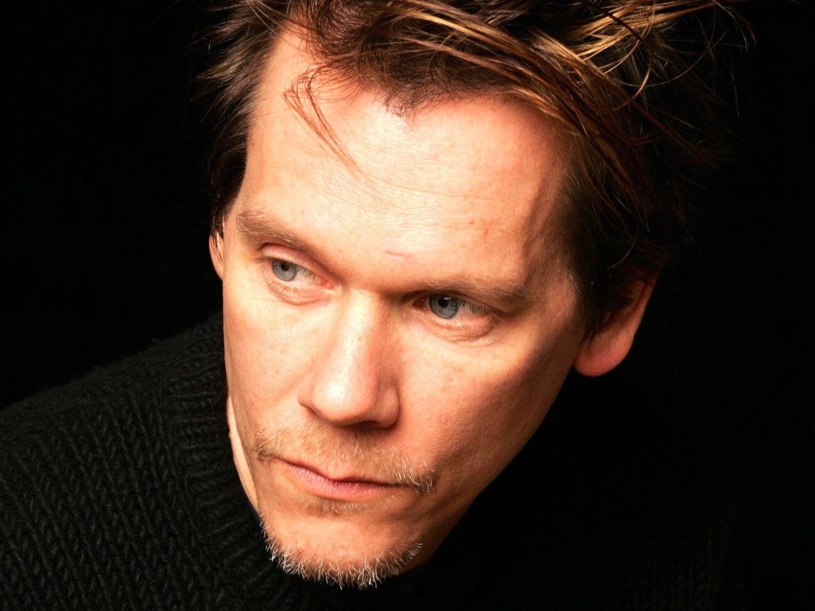 Hollywood Veteran Kevin Bacon In A Classic Black Suit Background