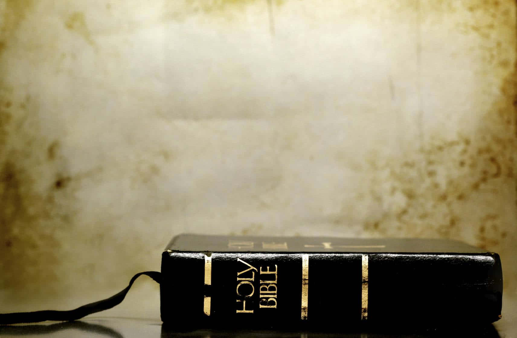 Holy Bible On Gradient Yellow Wall Background