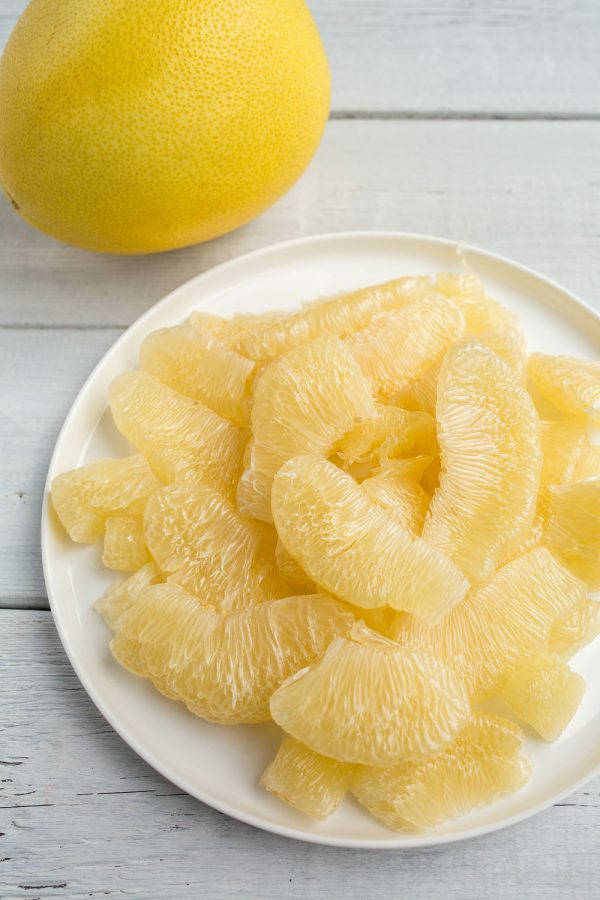 Honey Pomelo On Plate Background