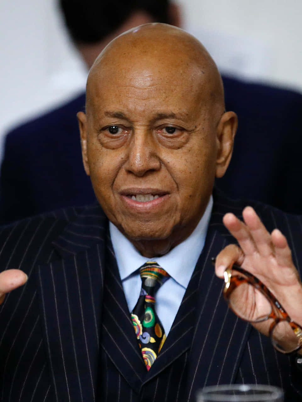 Honorable Alcee Hastings Posing With Glasses In Hand Background