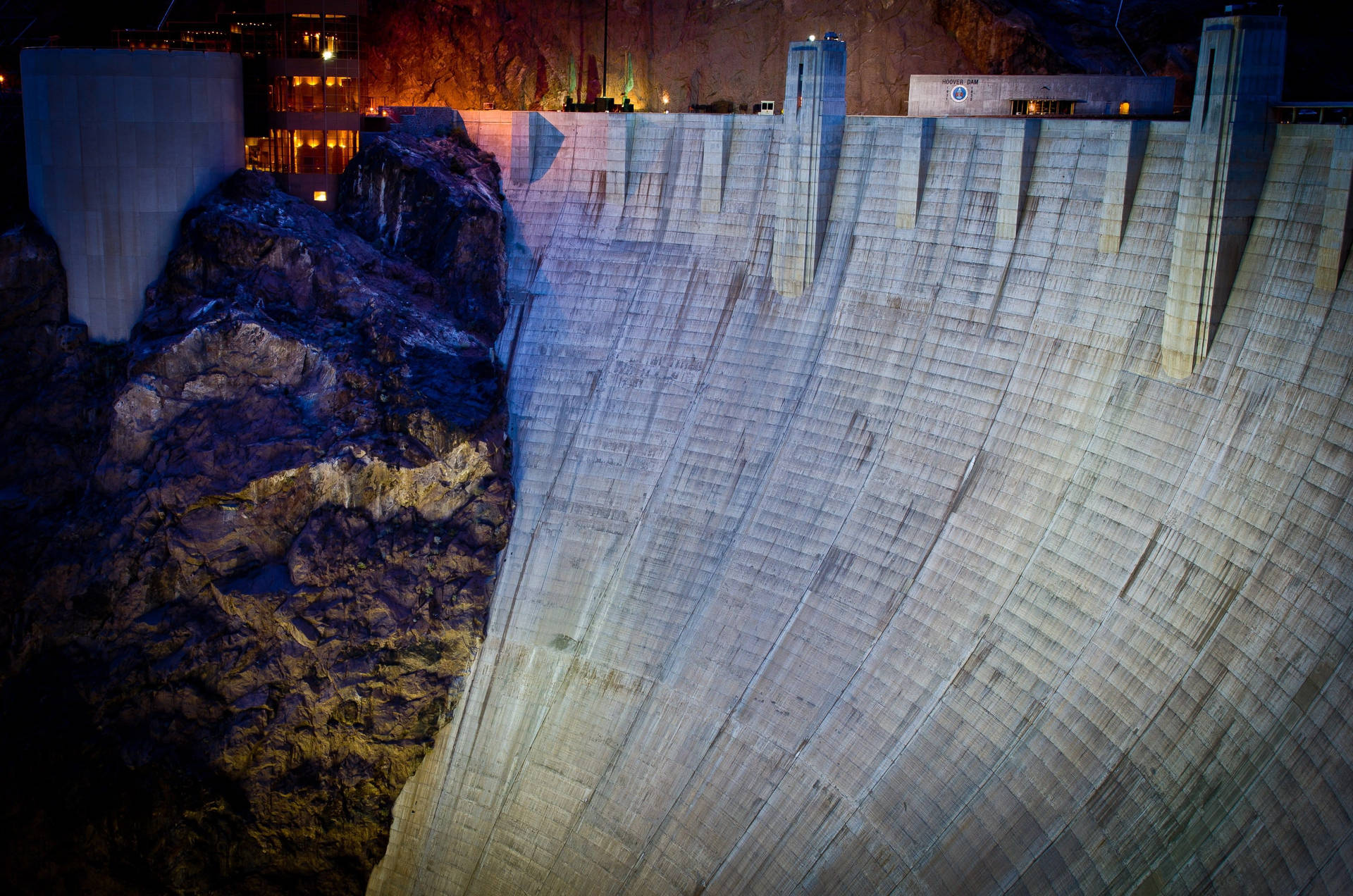 Hoover Dam Illuminated At Night Background