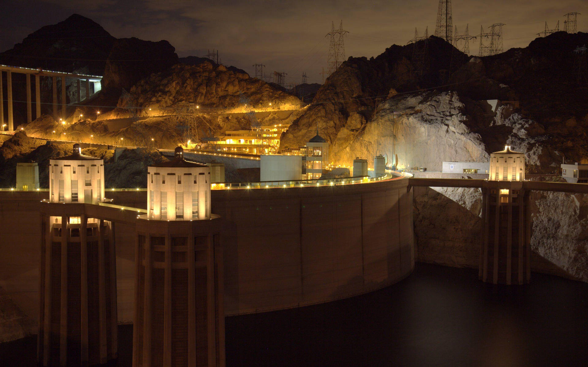 Hoover Dam With Lights At Night Background