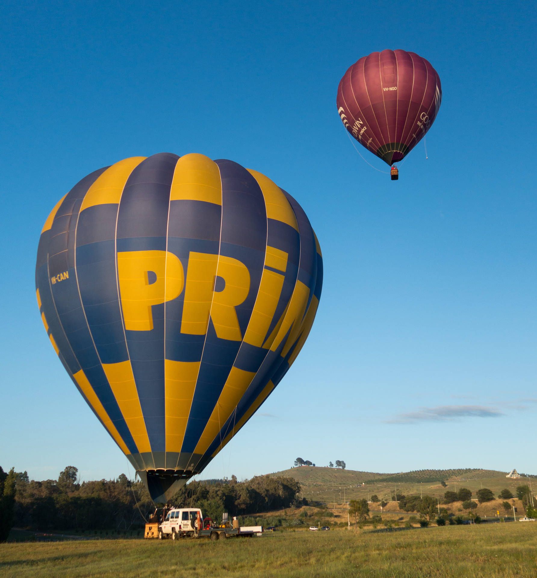 Hot Air Balloons Floating Over Canberra Background