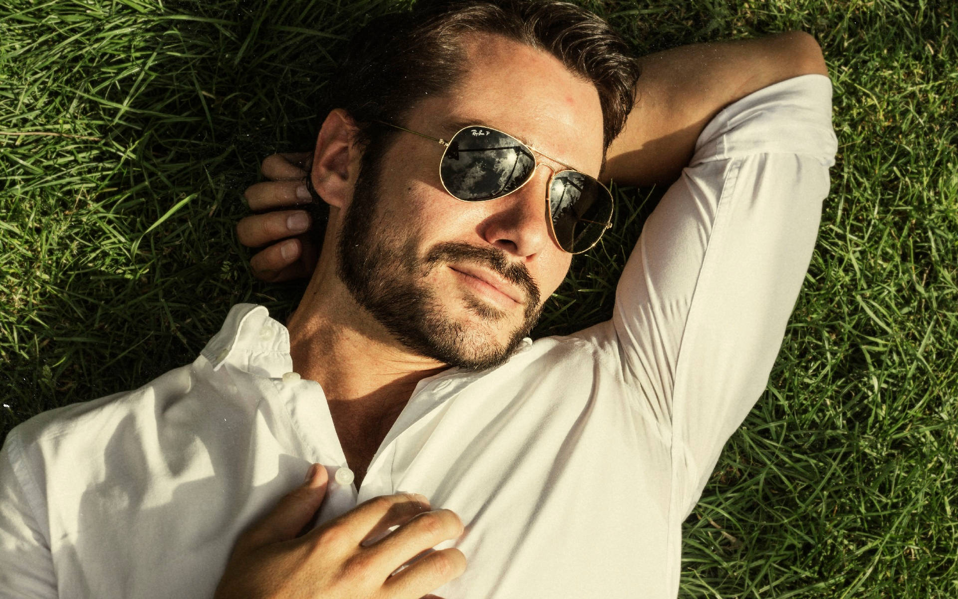 Hot Guy Lying On Grass Background