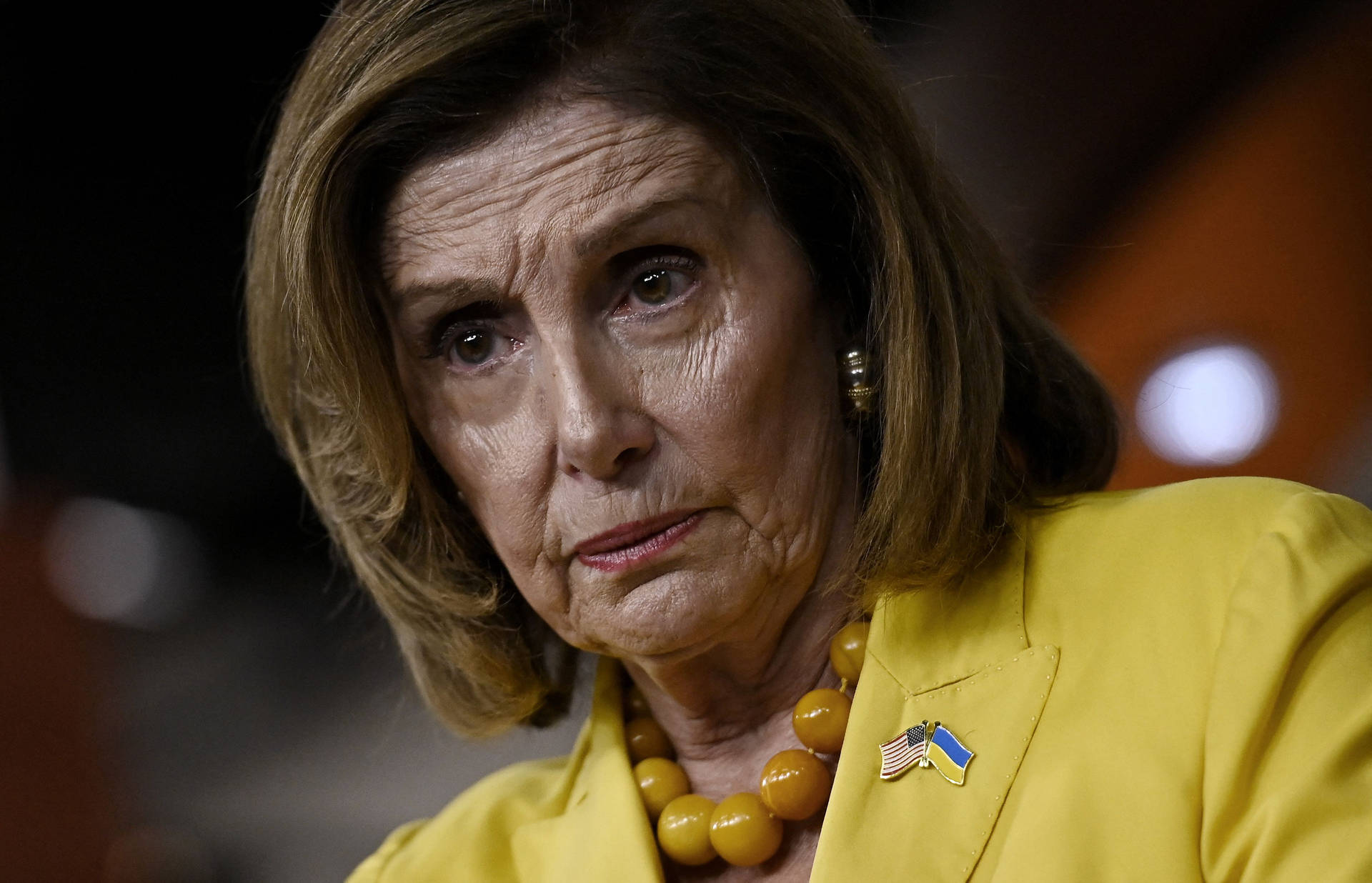 House Speaker Nancy Pelosi Dons Stylish Yellow Outfit Background