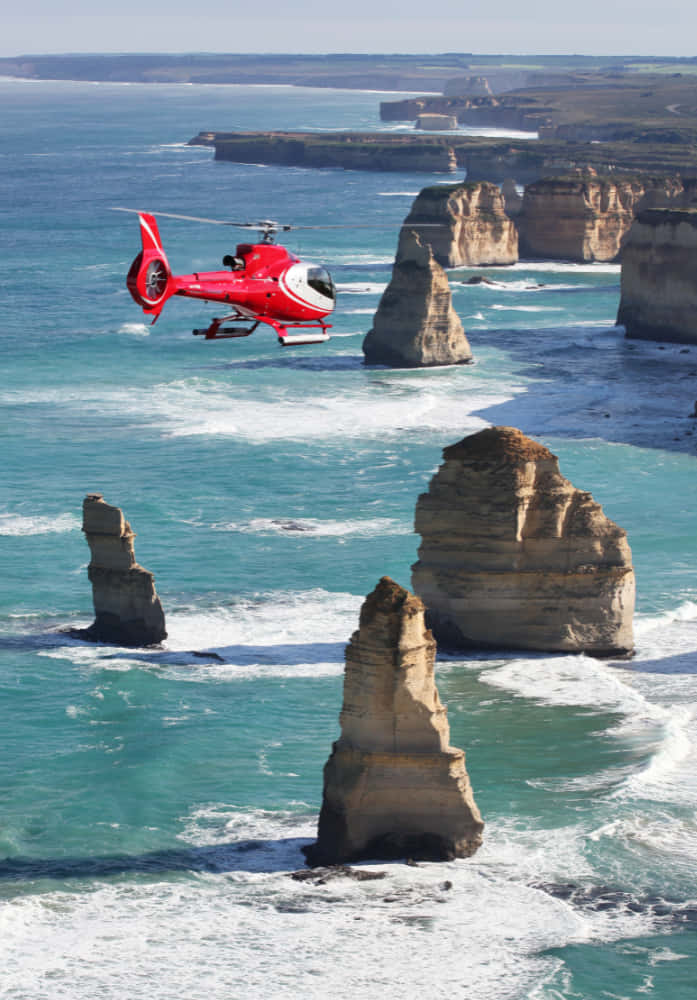 Hovering Helicopter In Twelve Apostles Australia Background
