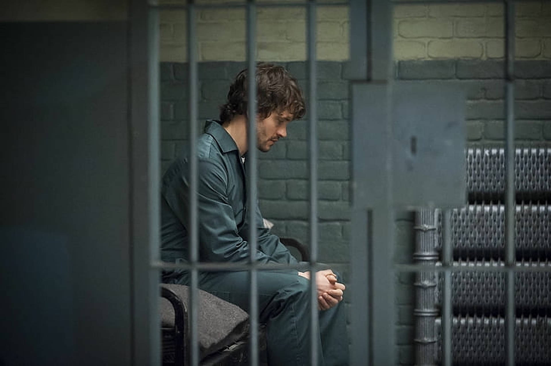Hugh Dancy In Prison Cell Background