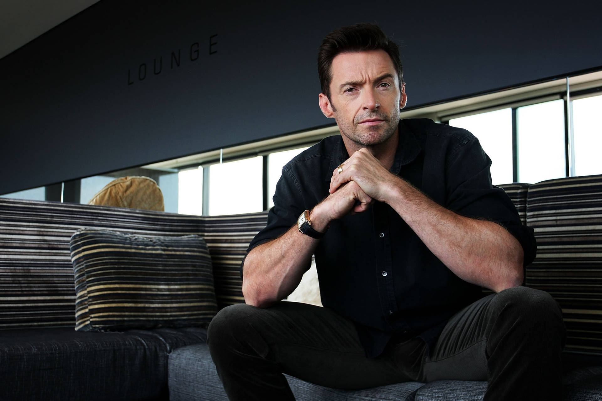 Hugh Jackman On Couch Background