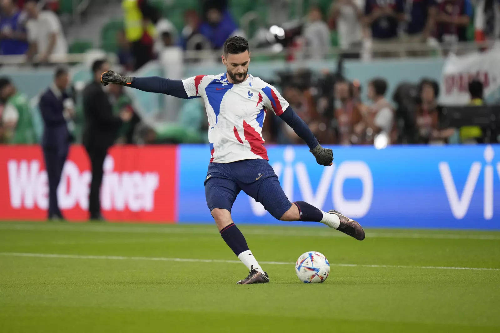 Hugo Lloris Expertly Kicks The Ball In A Game Background