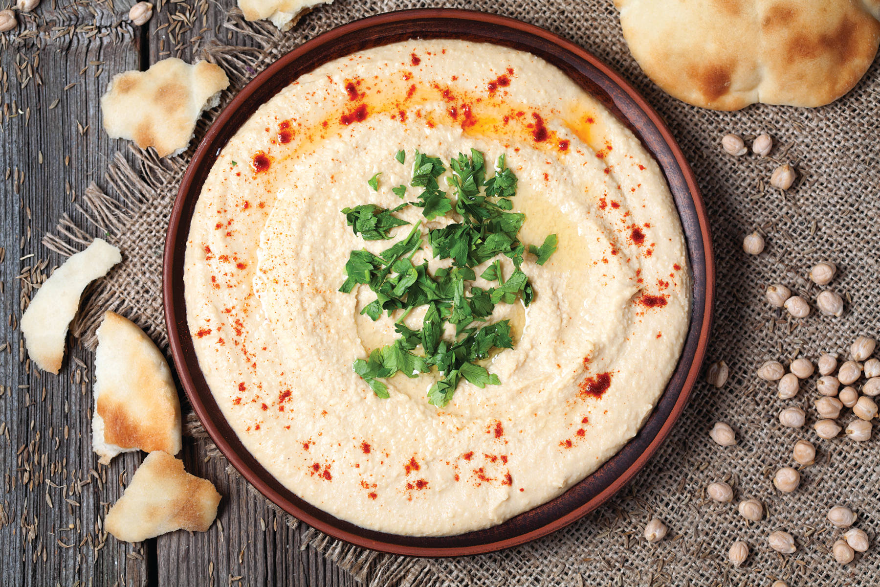 Hummus With Table Mat On Wood Background