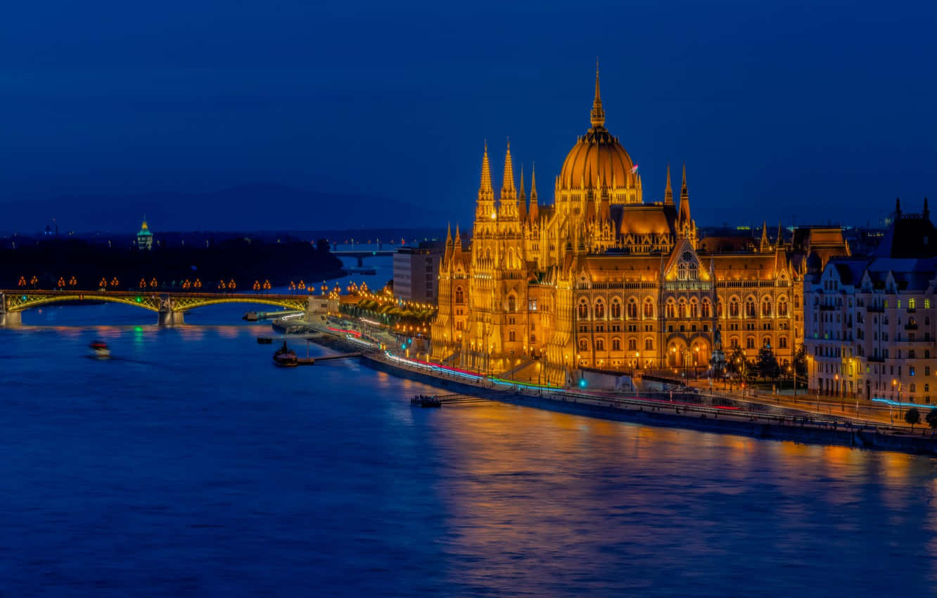 Hungarian Parliament Buildings Bridge At Night Background