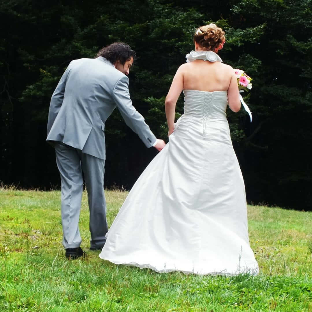 Husband And Wife Holding Hands On Grass Background