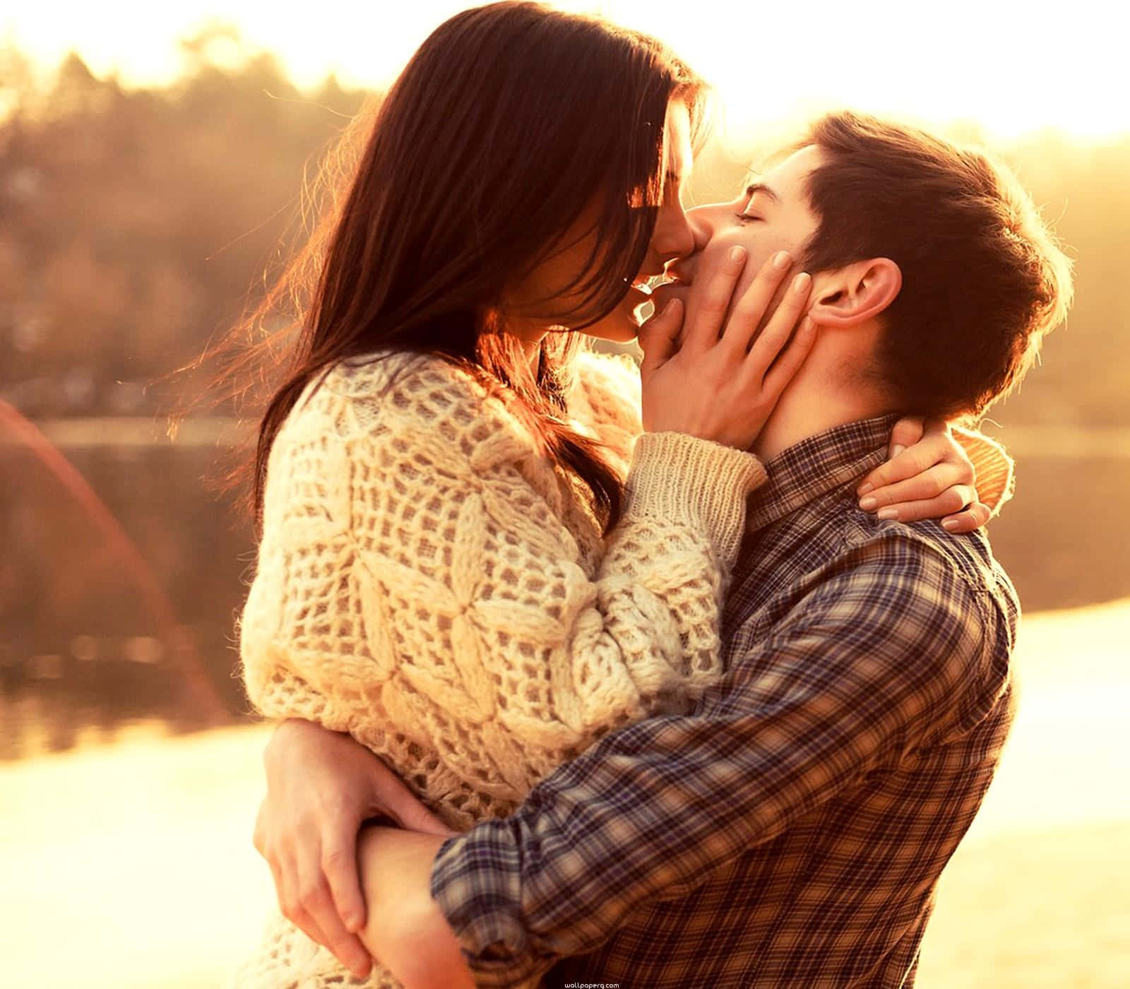 Husband And Wife Kissing At Sunset Background