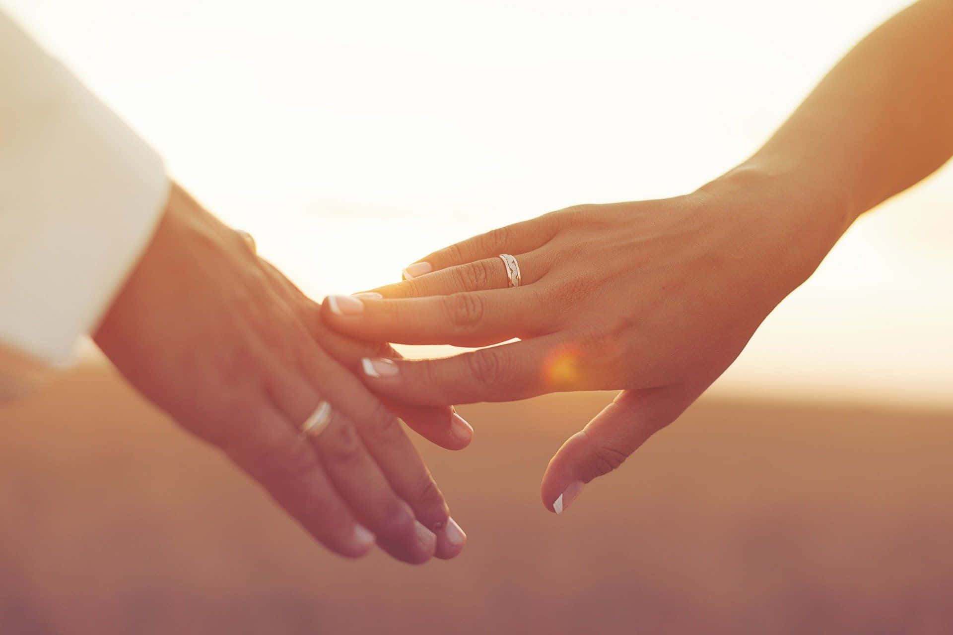 Husband And Wife Wedding Rings Sunset Background