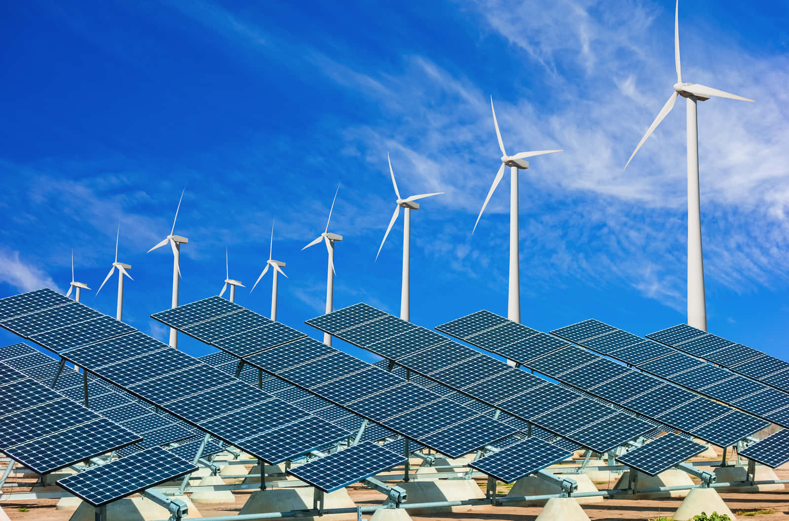 Hybrid Wind Turbine And Solar Panel Against Cloudy Sky Background