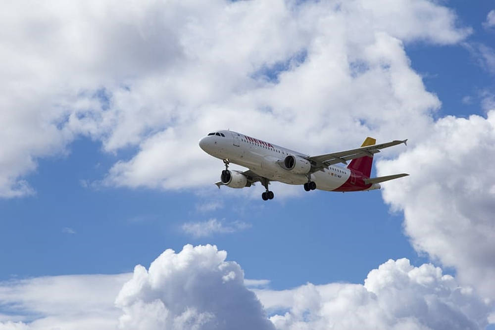 Iberia Airlines Airplane Emerging From Clouds