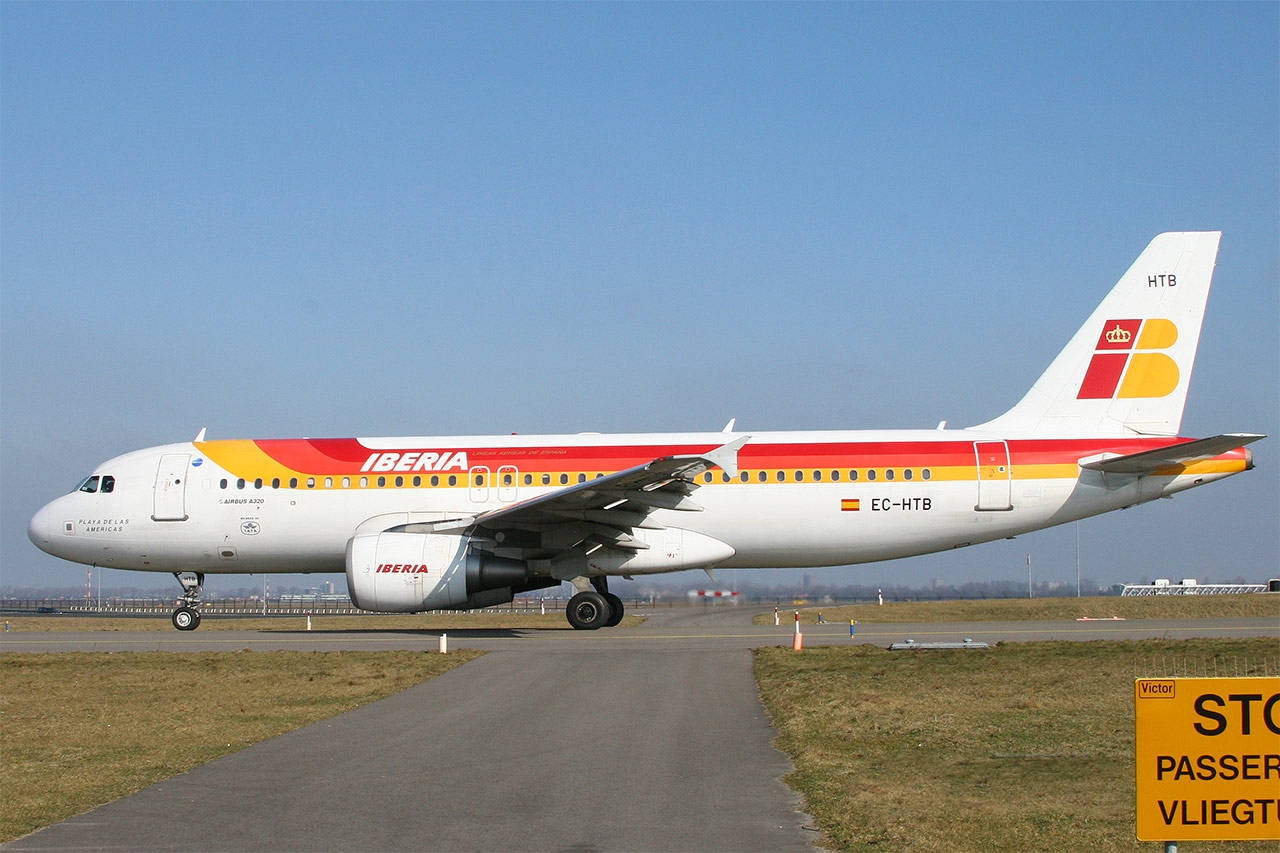 Iberia Airlines Airplane On Runway Crossroads Background