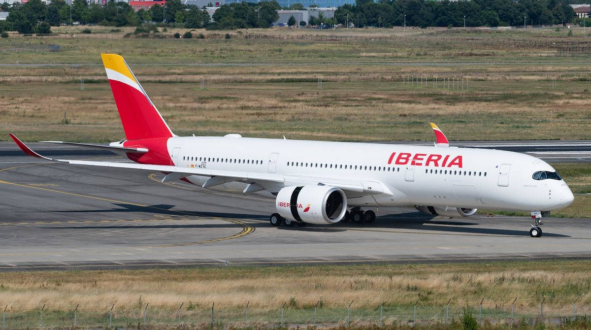 Iberia Airlines Passenger Airplane On Runway Background