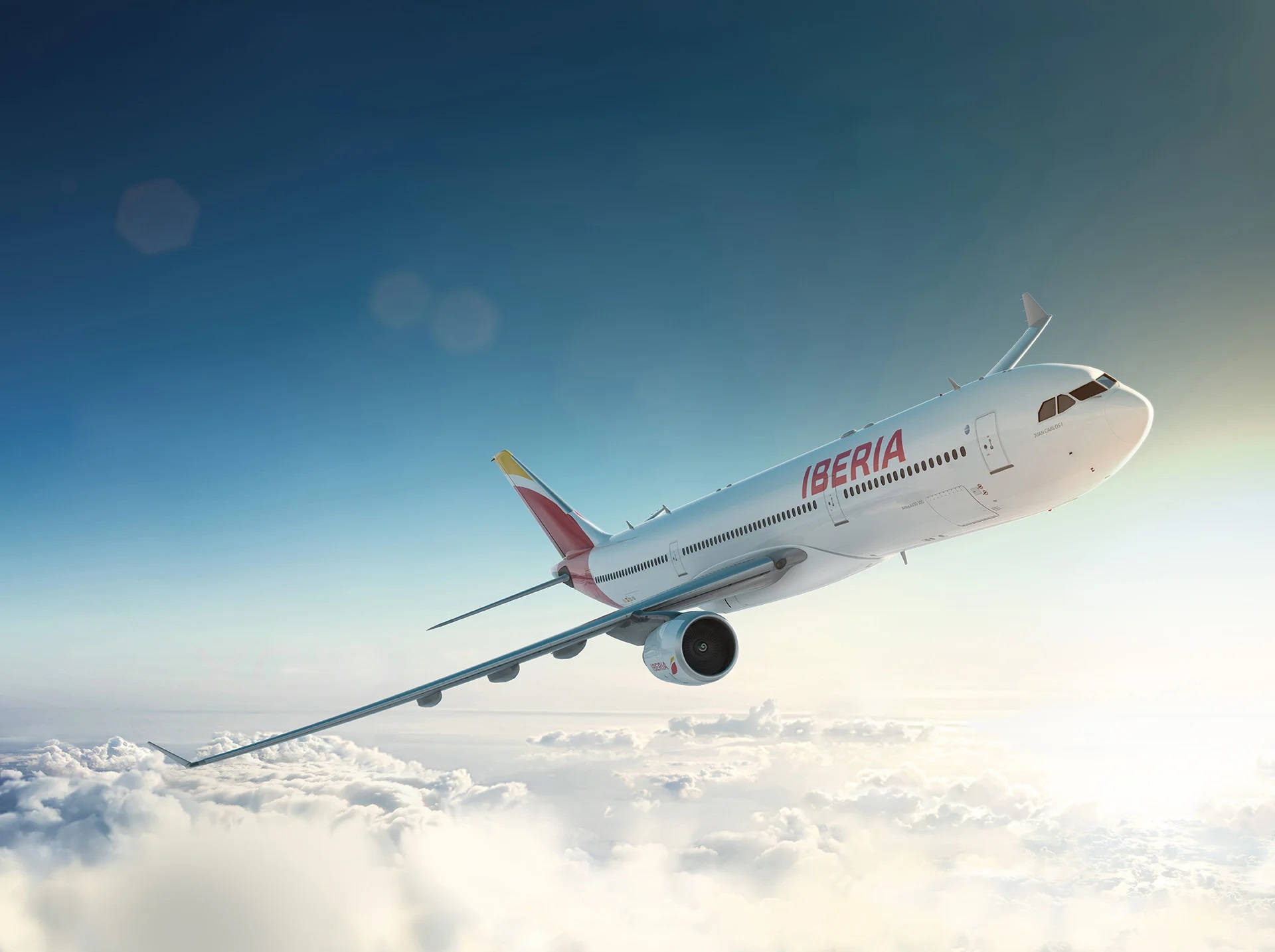 Iberia Airplane Gliding Sideways Above Clouds Background