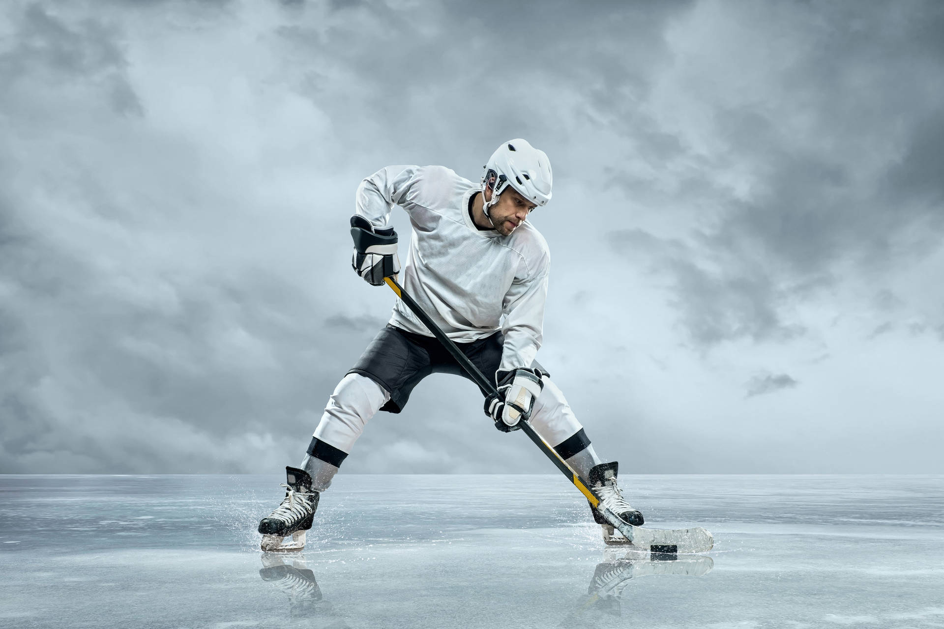 Ice Hockey Player Hitting The Puck Background