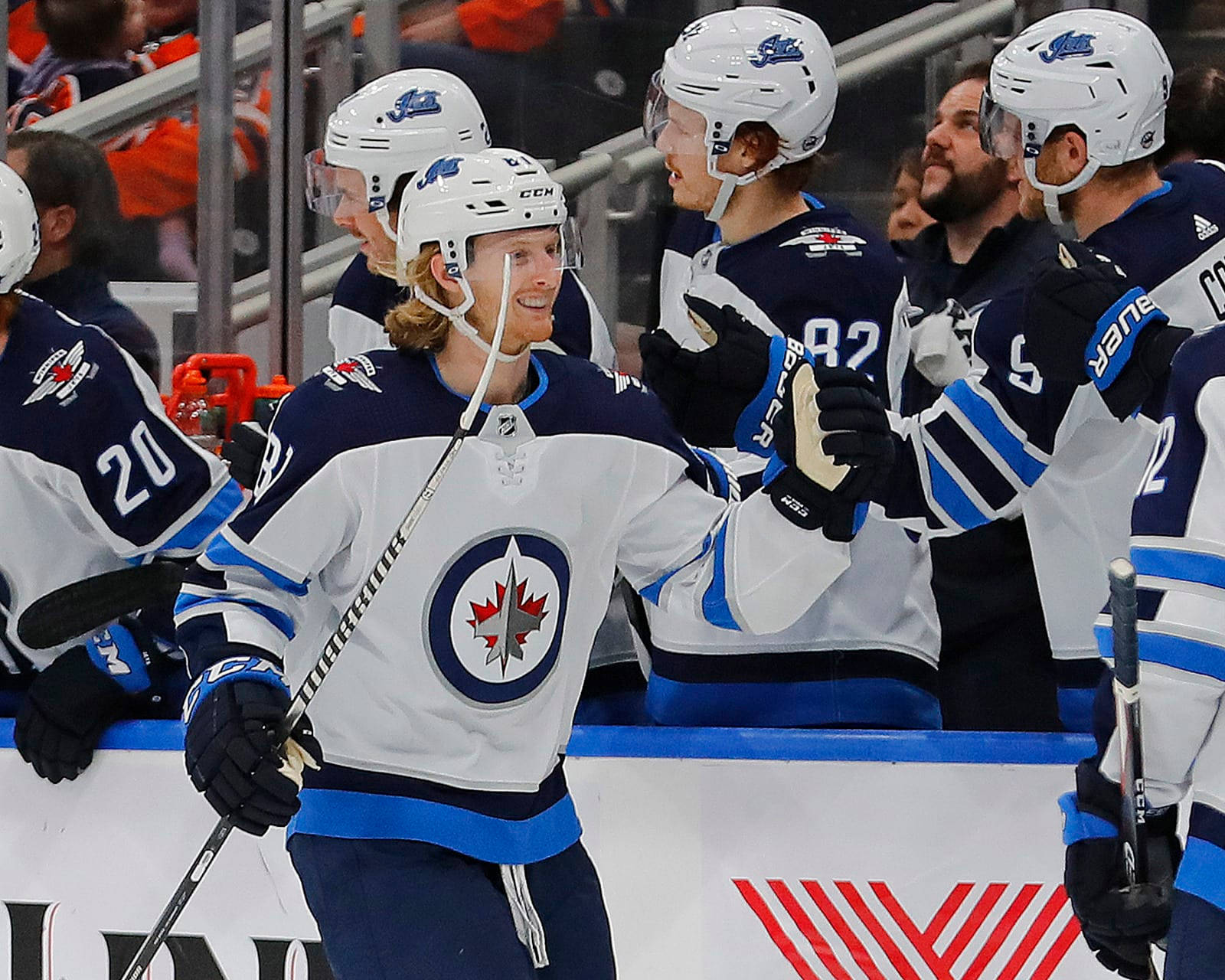 Ice Hockey Star Kyle Connor In Action With Winnipeg Jets Teammates Background