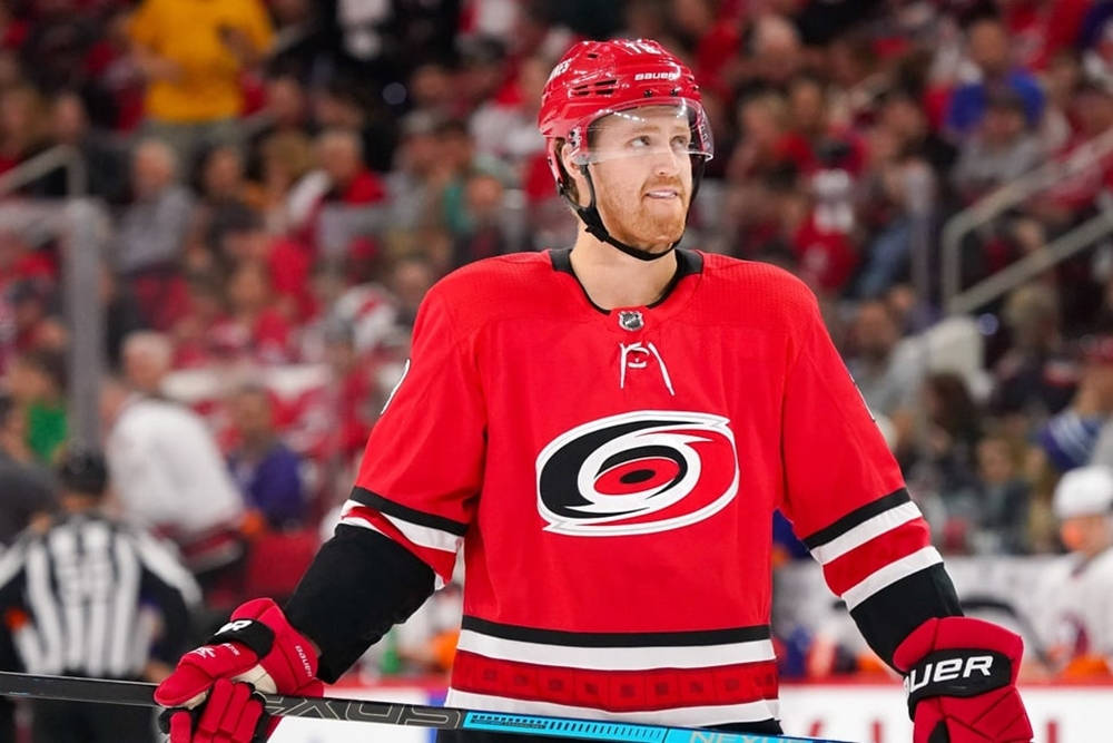 Ice Hockey Superstar Dougie Hamilton Celebrating Victory To Cheering Crowd Of Carolina Hurricanes Background