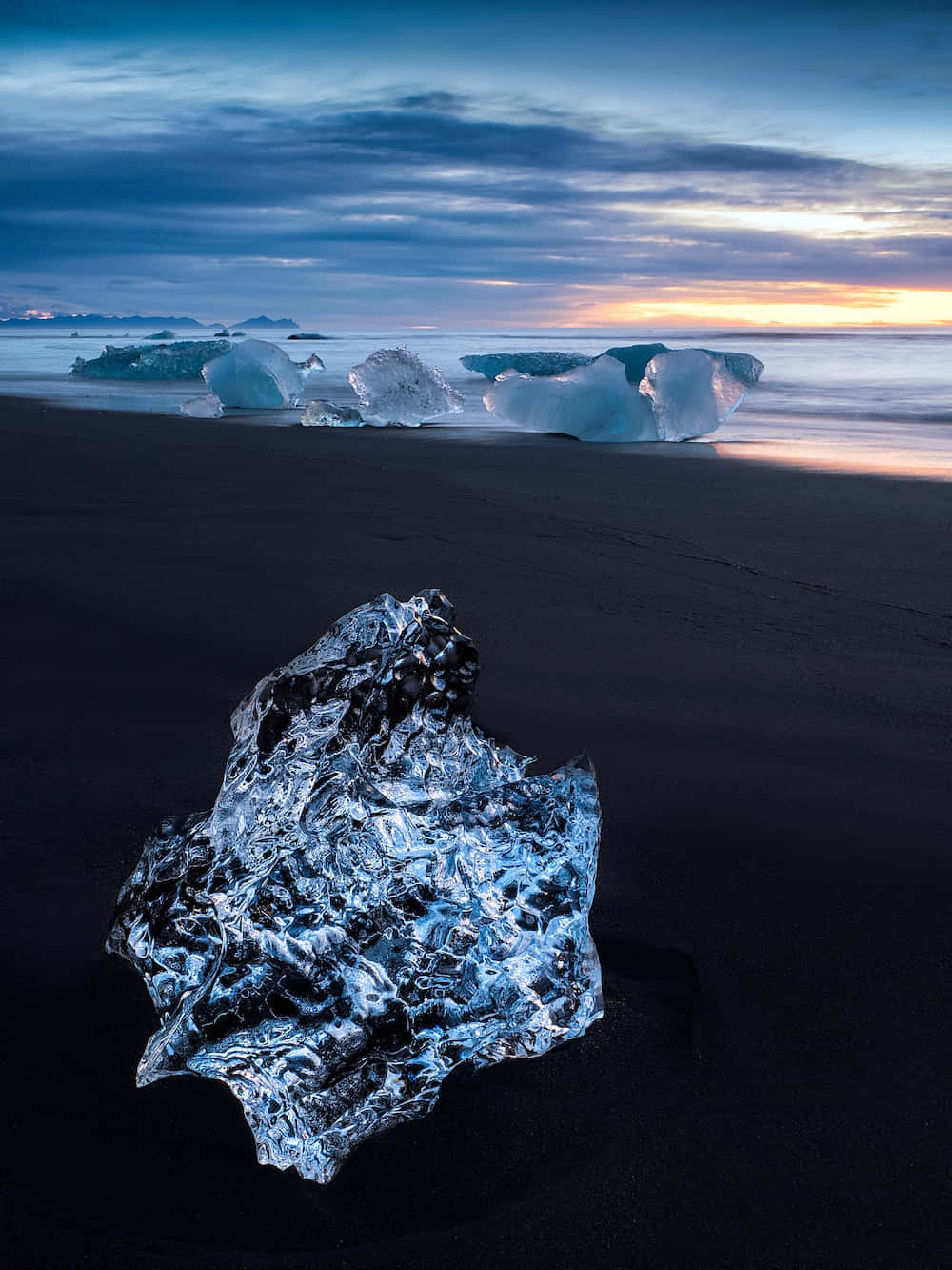 Icebergs On The Beach At Sunset Background