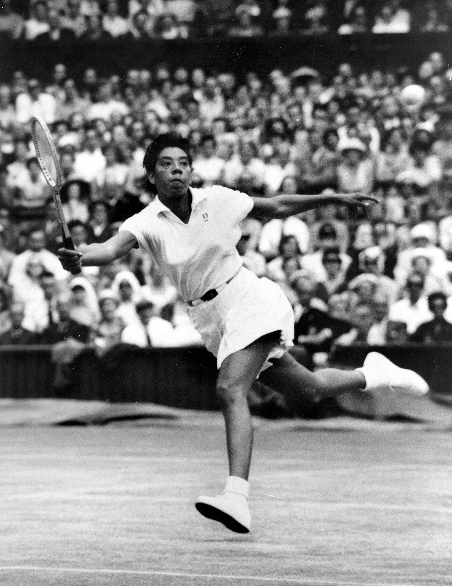 Iconic Althea Gibson Swinging Tennis Racket Background