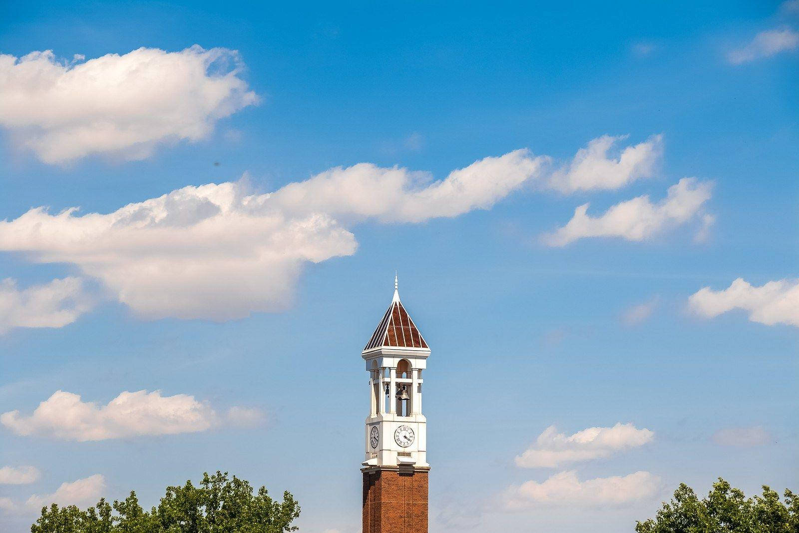 Iconic Bell Tower At Purdue University Under A Cloudy Sky Background