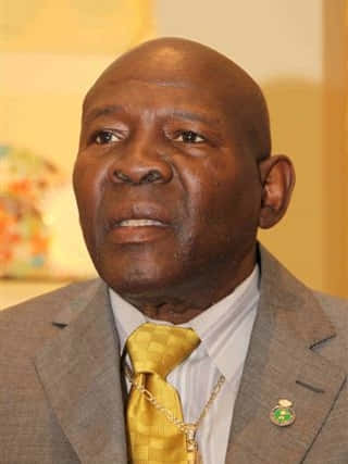 Iconic Boxer Emile Griffith In Elegant Gray Suit Background