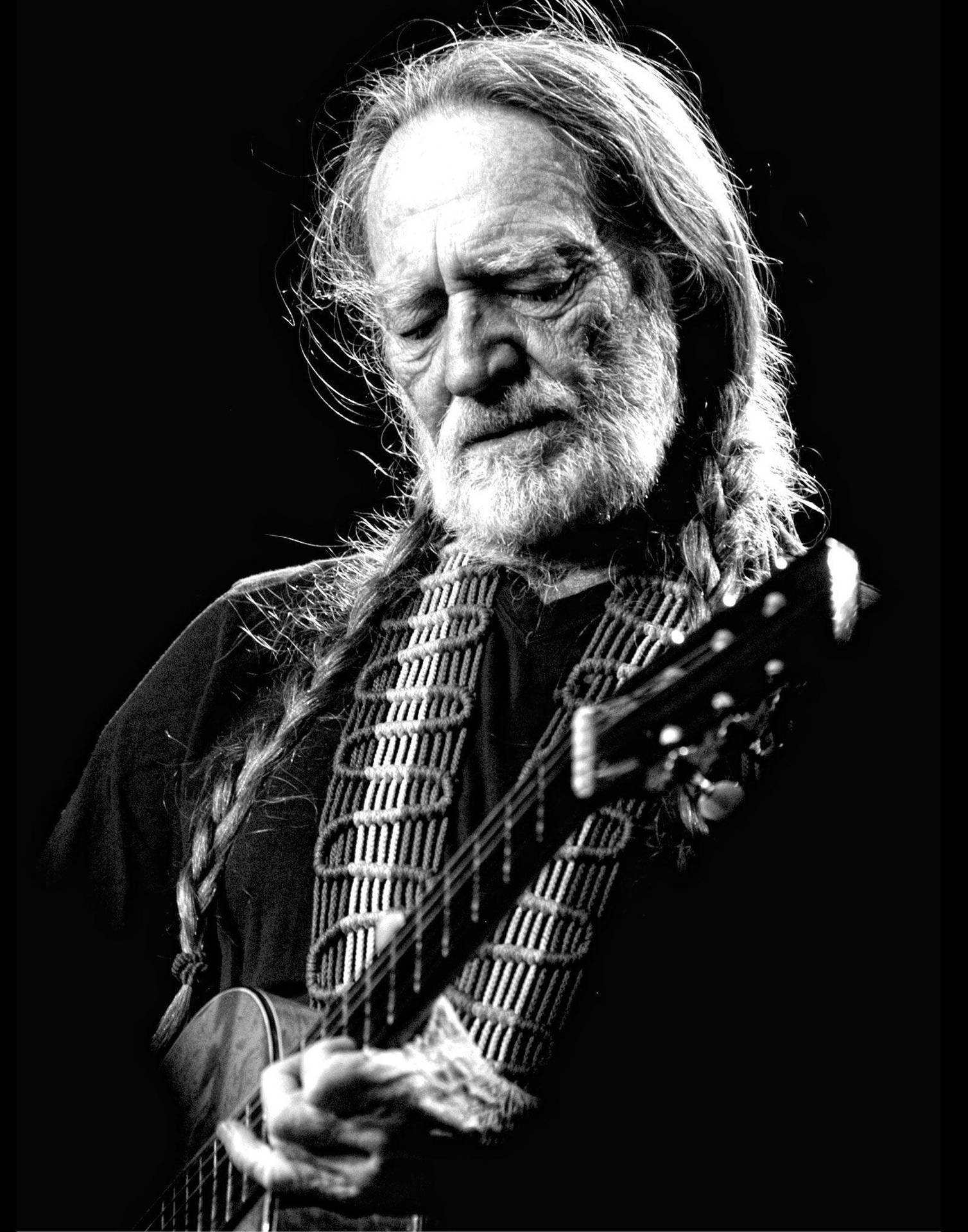 Iconic Country Music Legend Willie Nelson In Monochrome Background