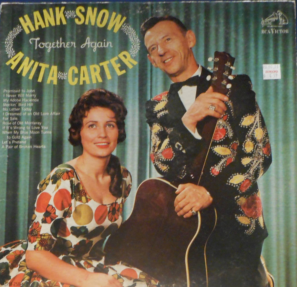 Iconic Country Singers Hank Snow And Anita Carter Performing Together Background