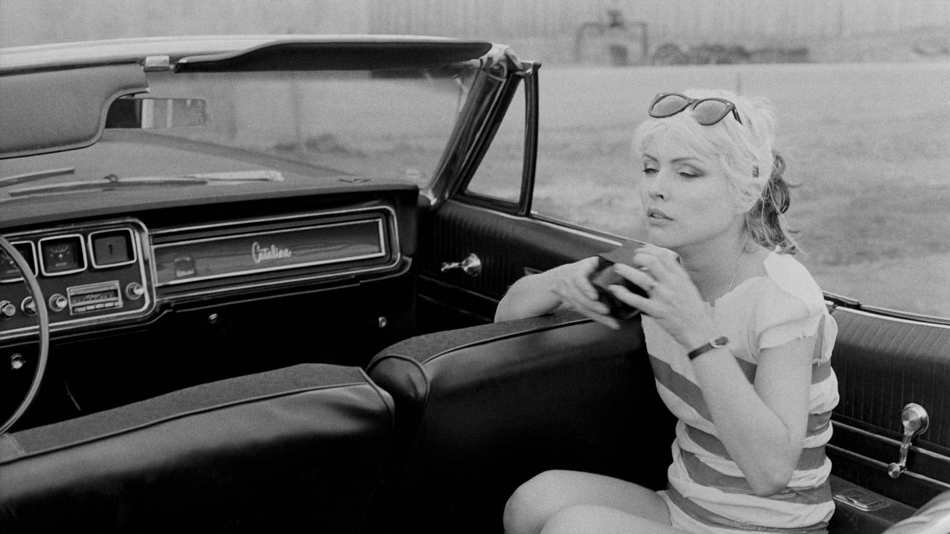 Iconic Debbie Harry Of Blondie In Vintage Car Photoshoot Background