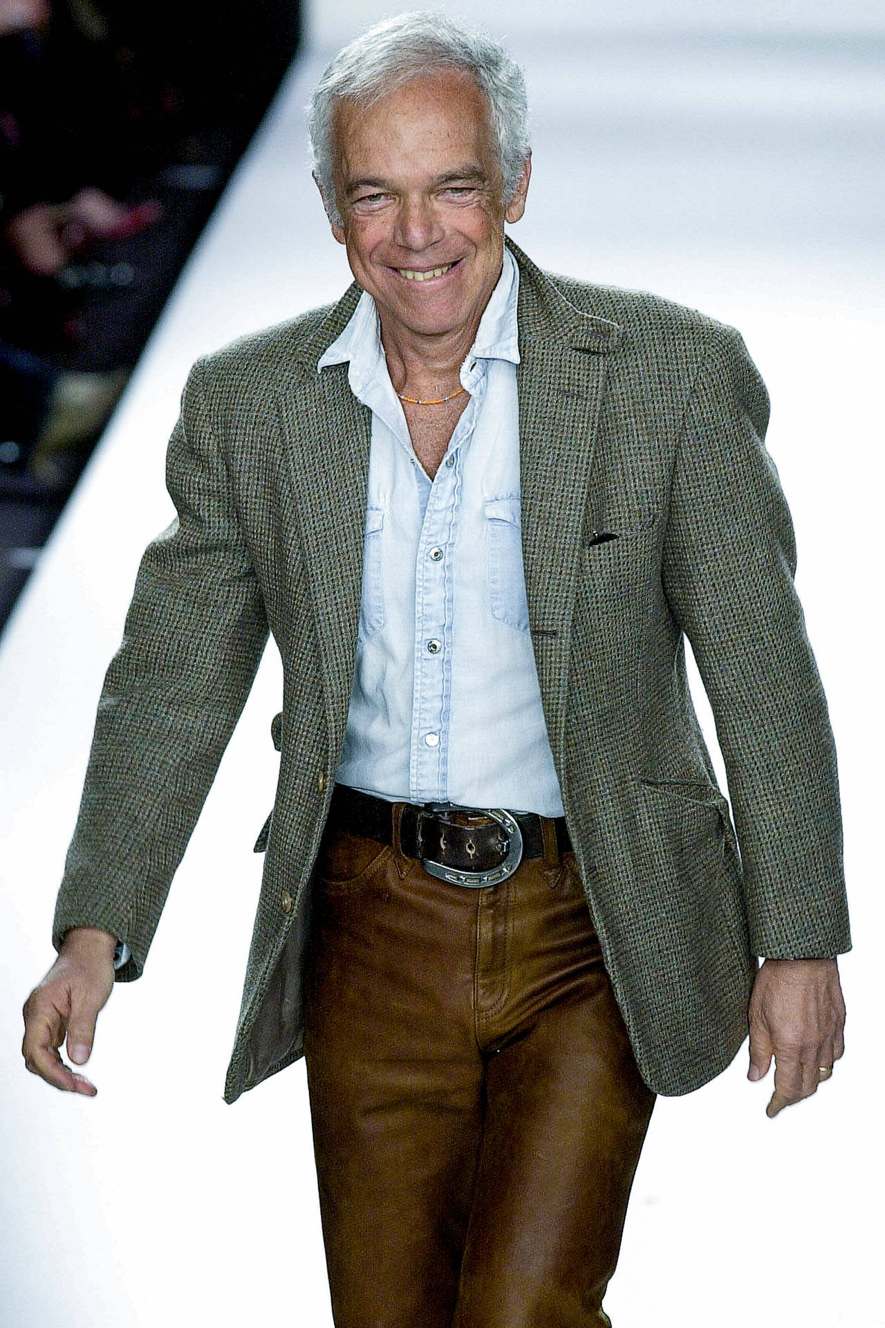 Iconic Fashion Designer Ralph Lauren Smiling Background