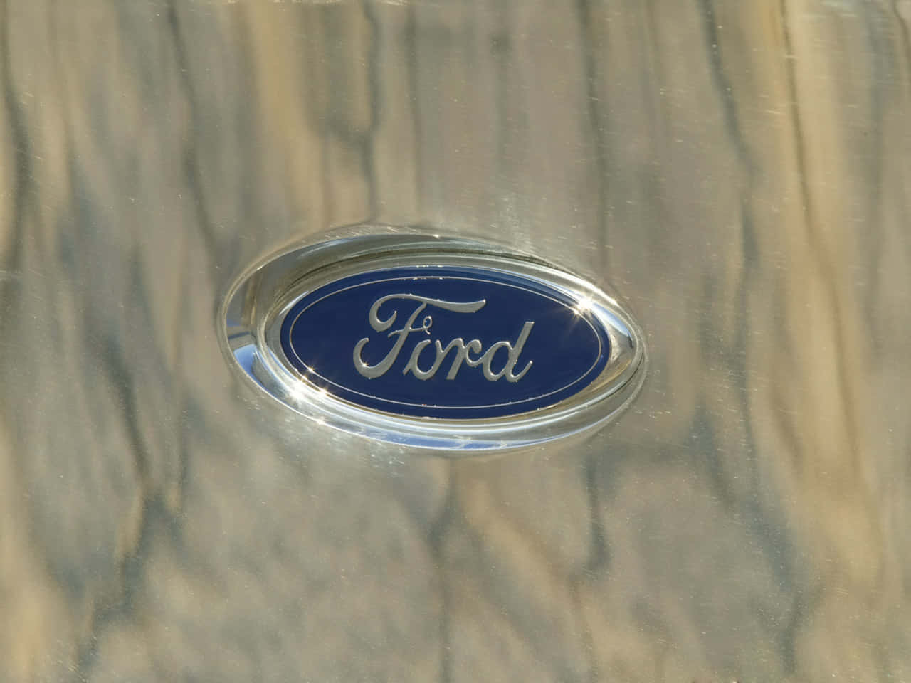 Iconic Ford Logo On A Stunning Blue Metallic Background Background