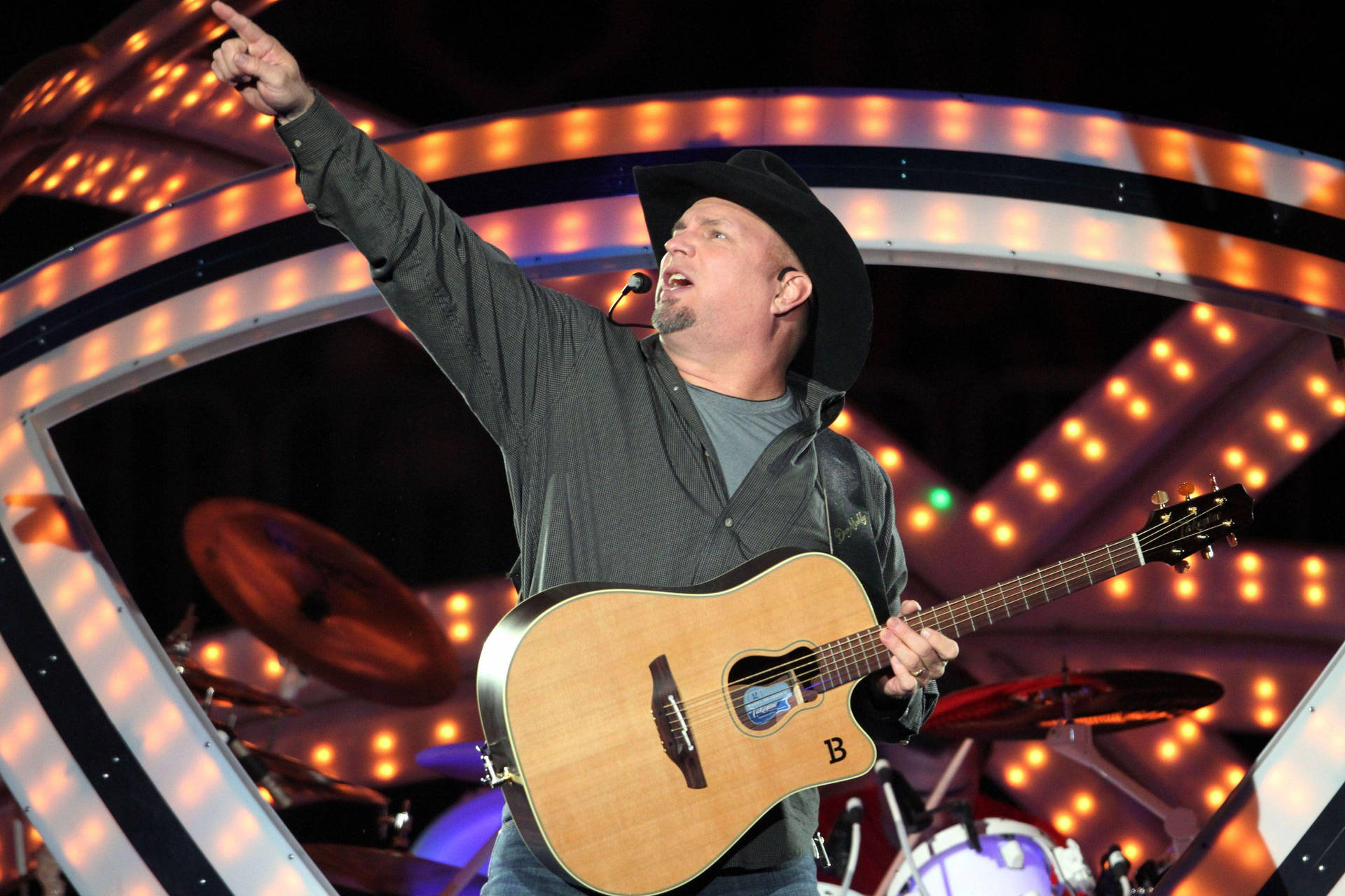 Iconic Garth Brooks In A Stylish Gray Suit Background