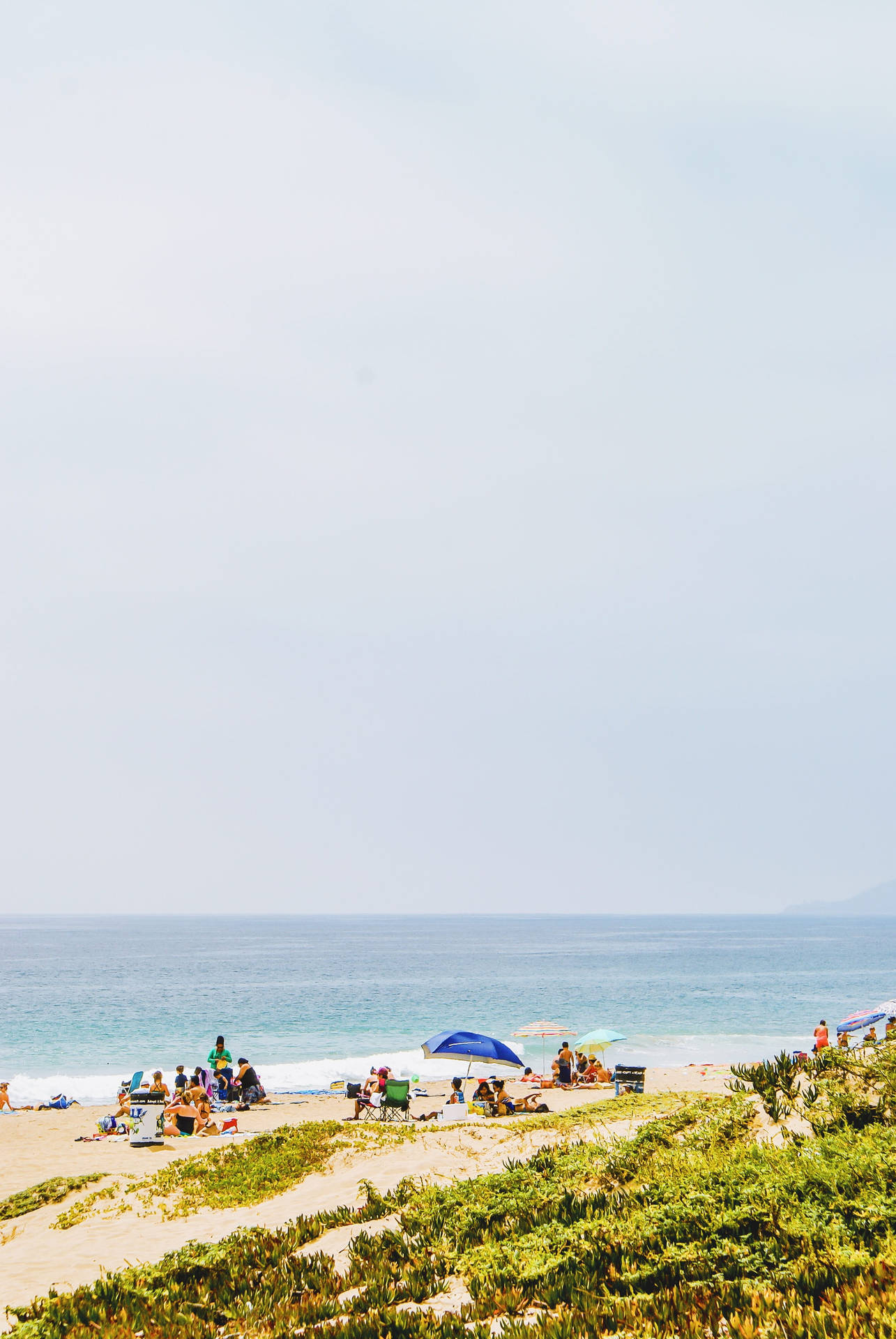 Iconic Malibu Beach With People Background