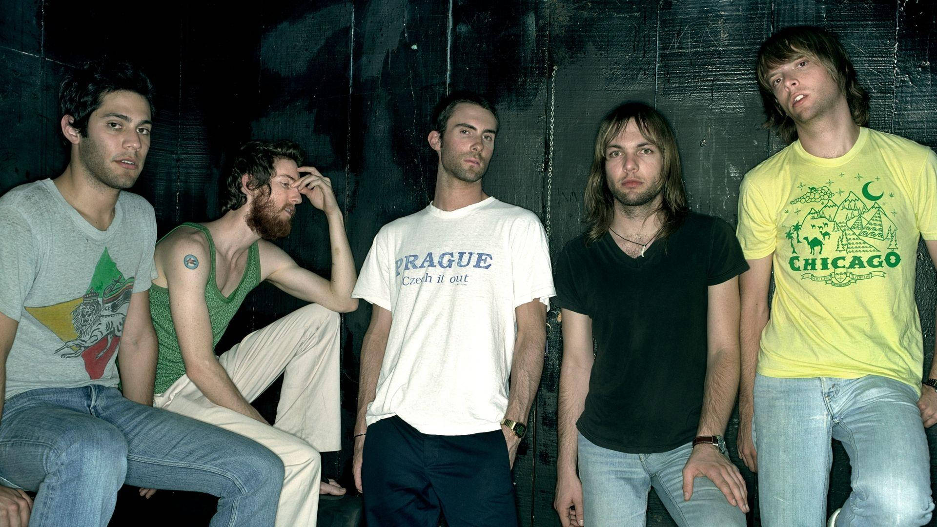 Iconic Maroon 5 Band Members Posing In Stylish Attire Background