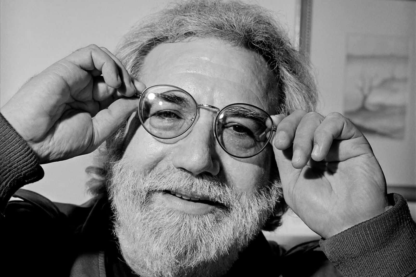 Iconic_ Musician_ Jerry_ Garcia_ Adjusting_ Glasses Background