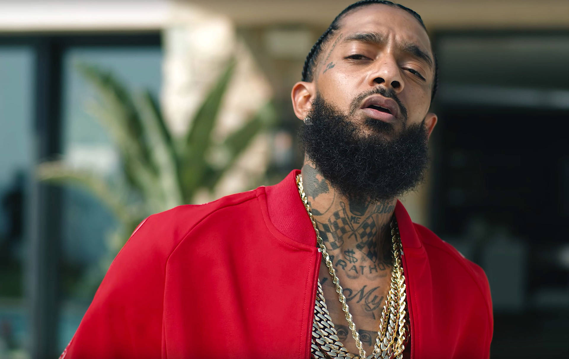 Iconic Nipsey Hussle Spreading His Unique Charm In The Music Studio Background