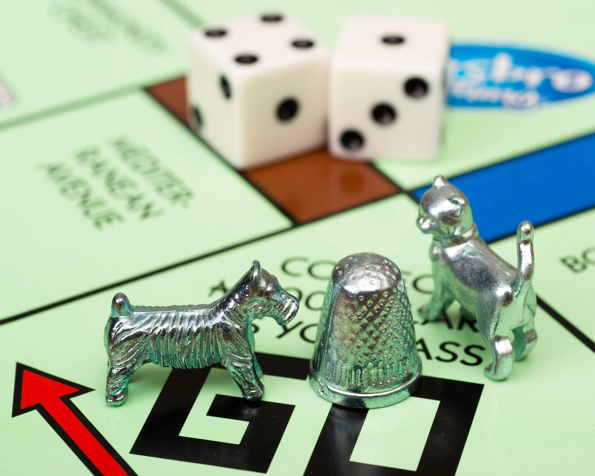 Iconic Silver Game Pieces Of Monopoly Board Game Background