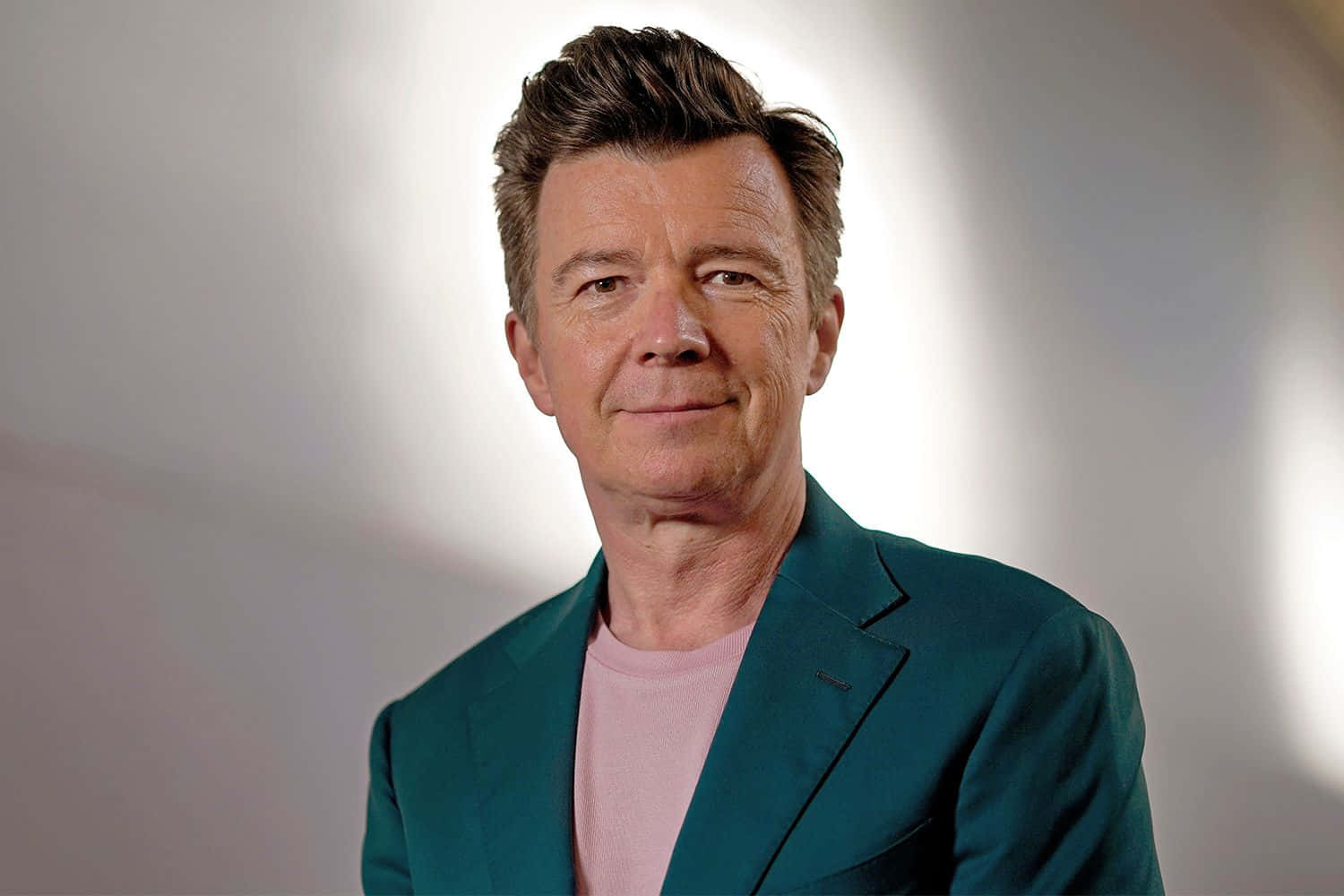 Iconic Singer Rick Astley At A Performance Background