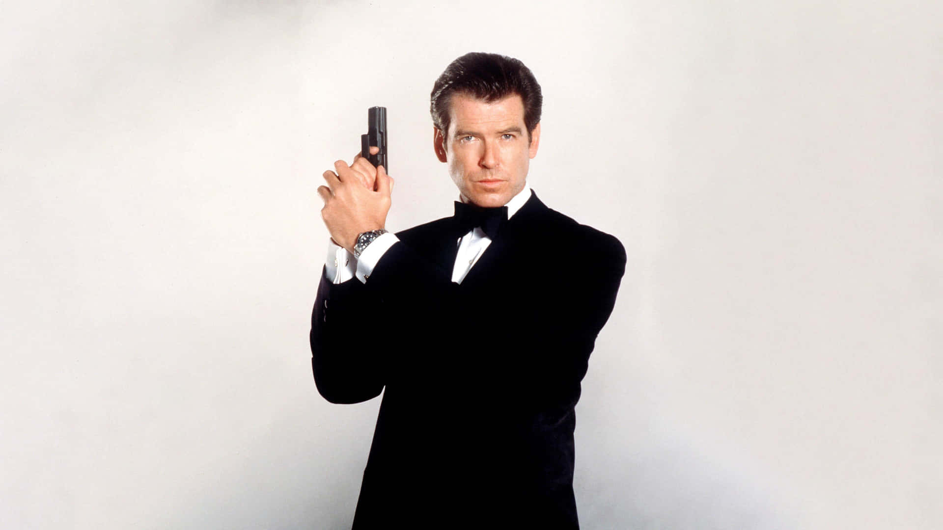 Iconic Spyin Tuxedo With Gun Background