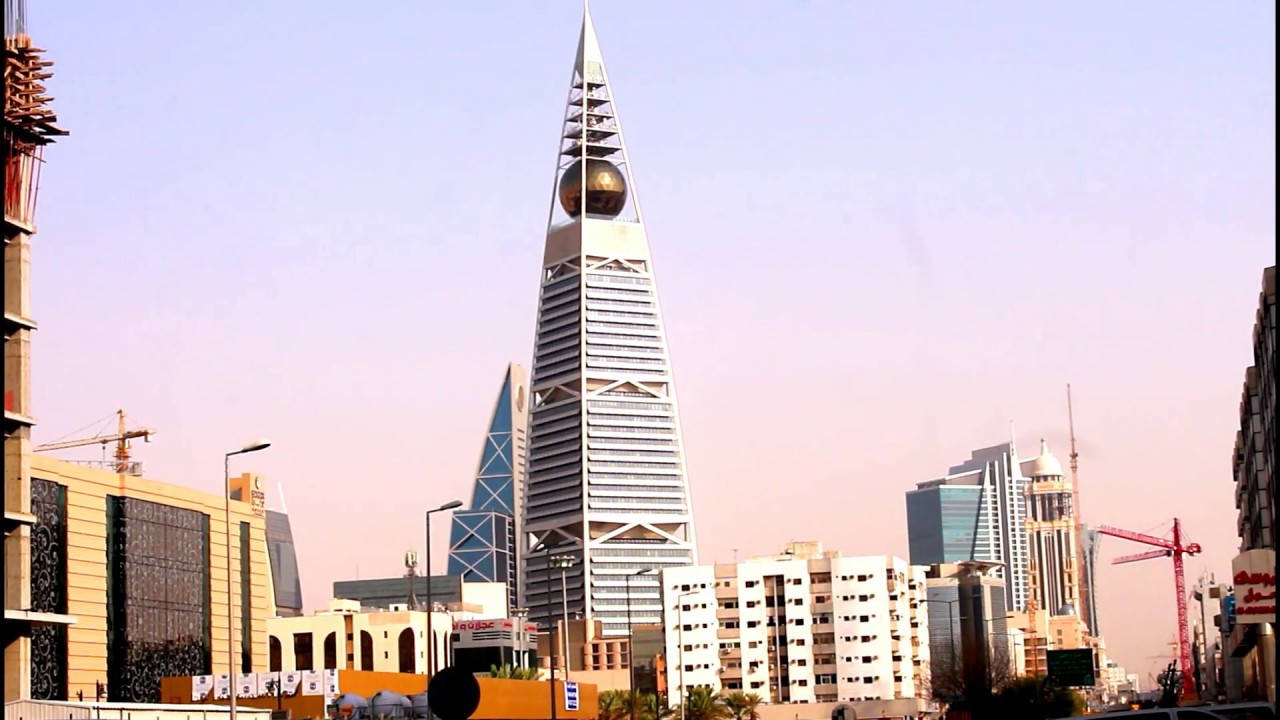 Iconic Triangular Tower Of Vibrant Riyadh At Dusk Background