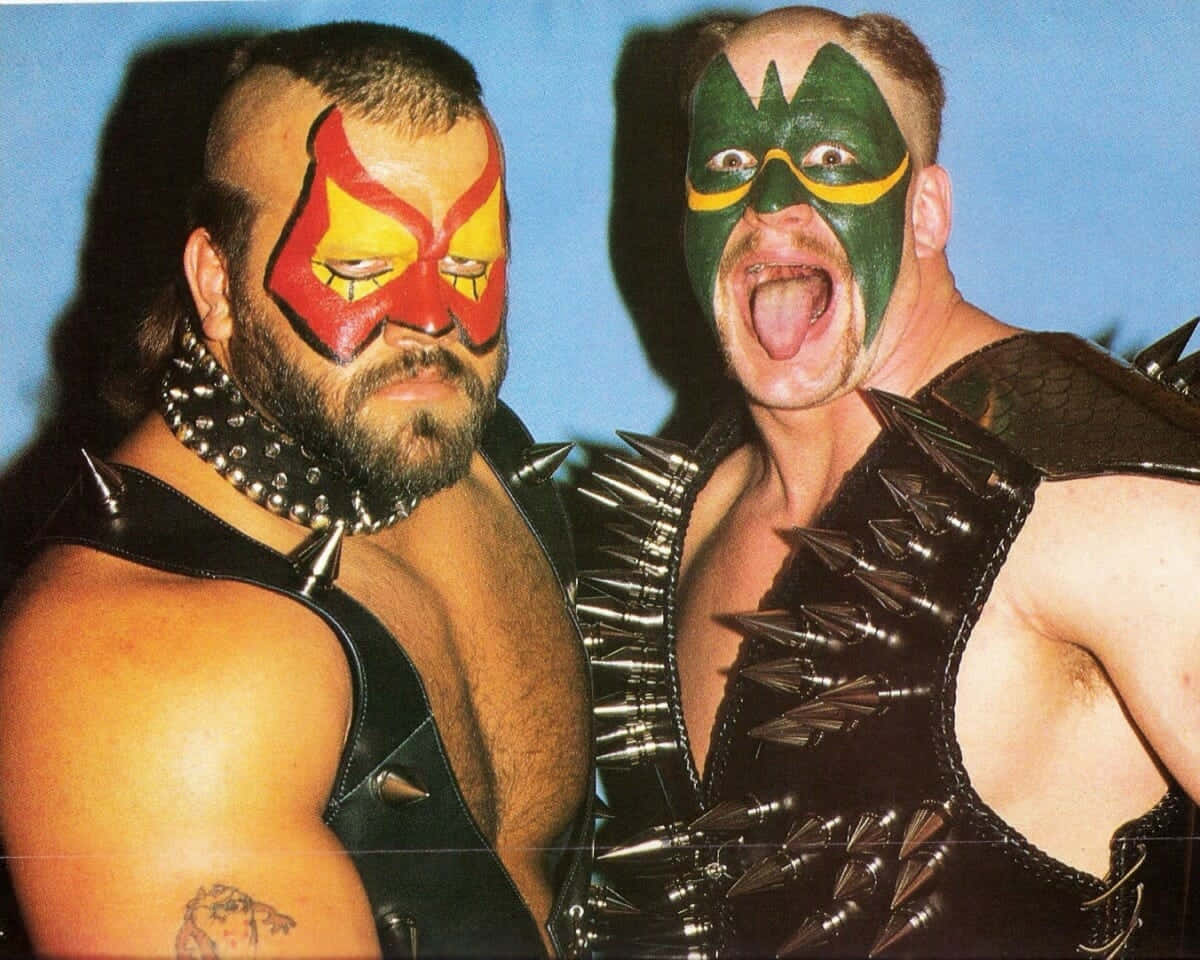 Iconic_ Wrestling_ Duo_ Face_ Paint_and_ Spikes Background