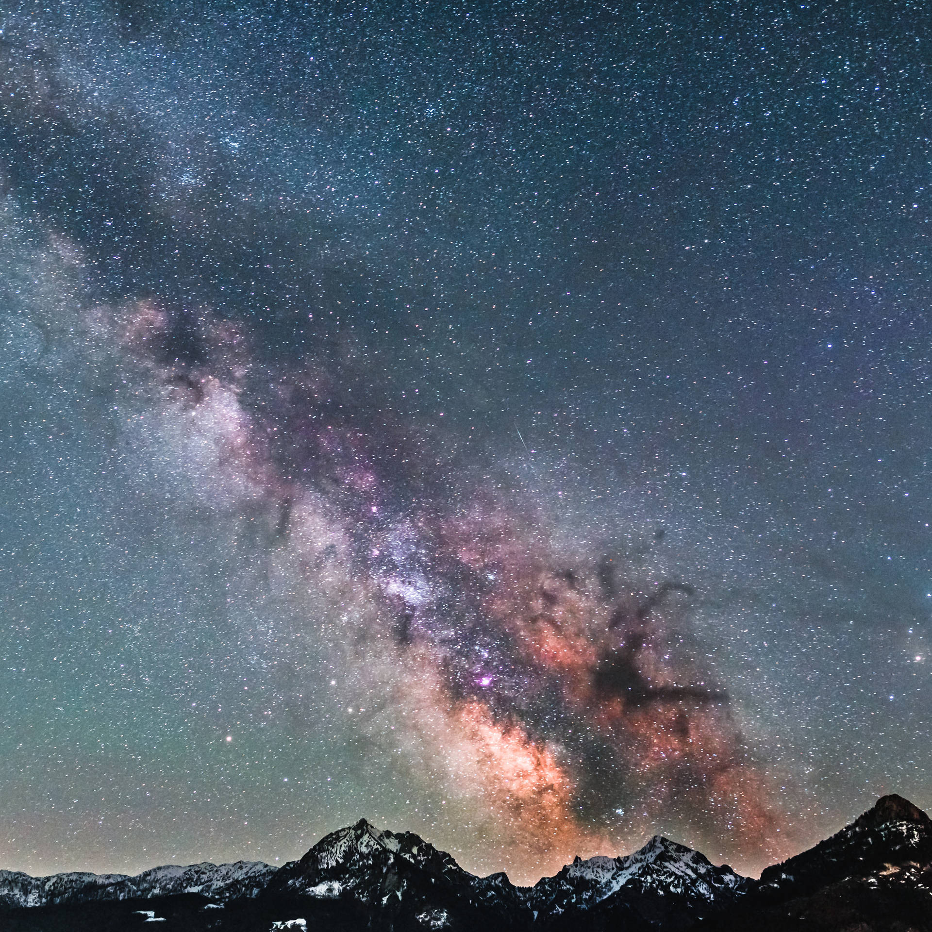 Icy Mountain Top Over The Milky Way Background