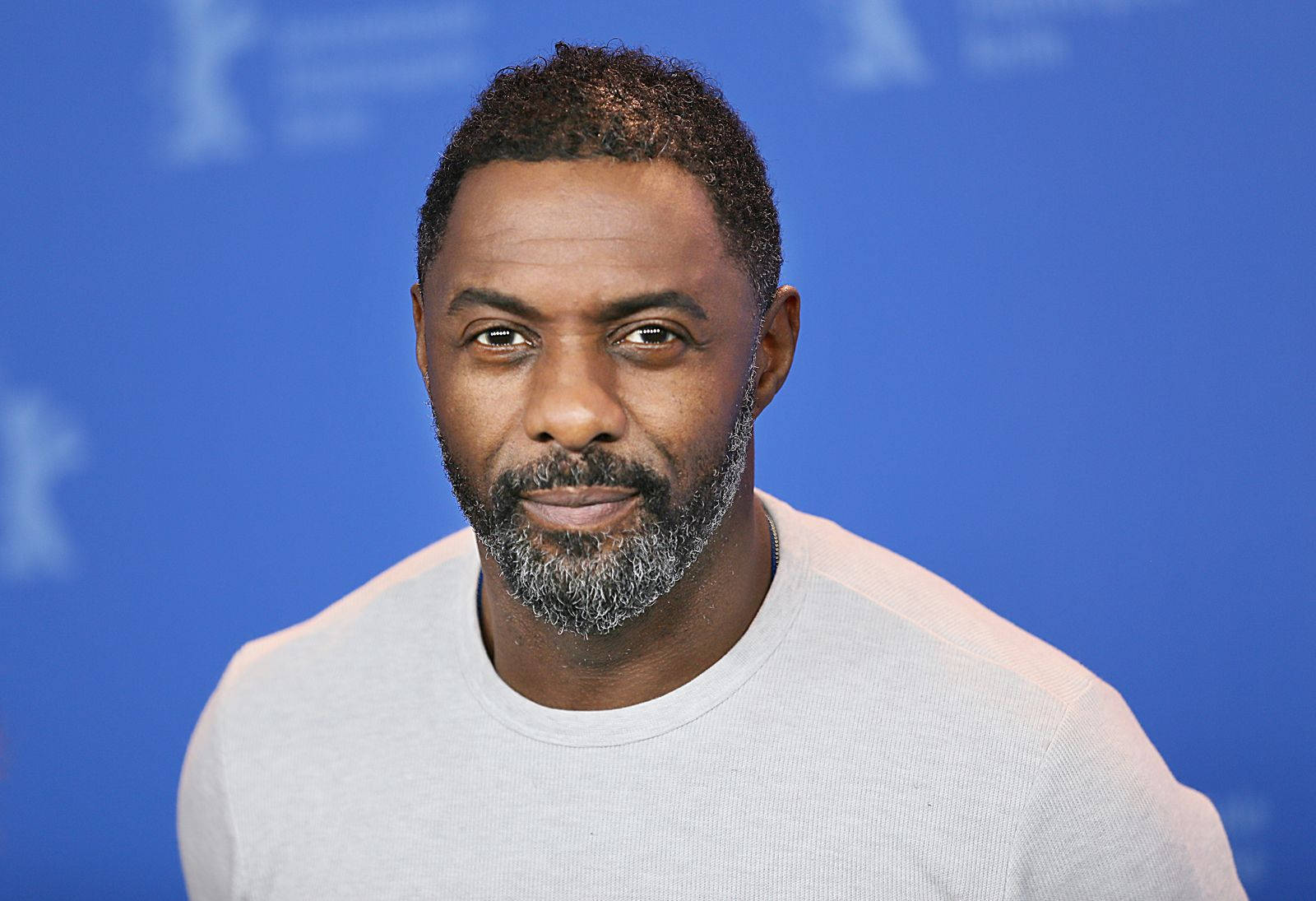 Idris Elba Against Blue Backdrop