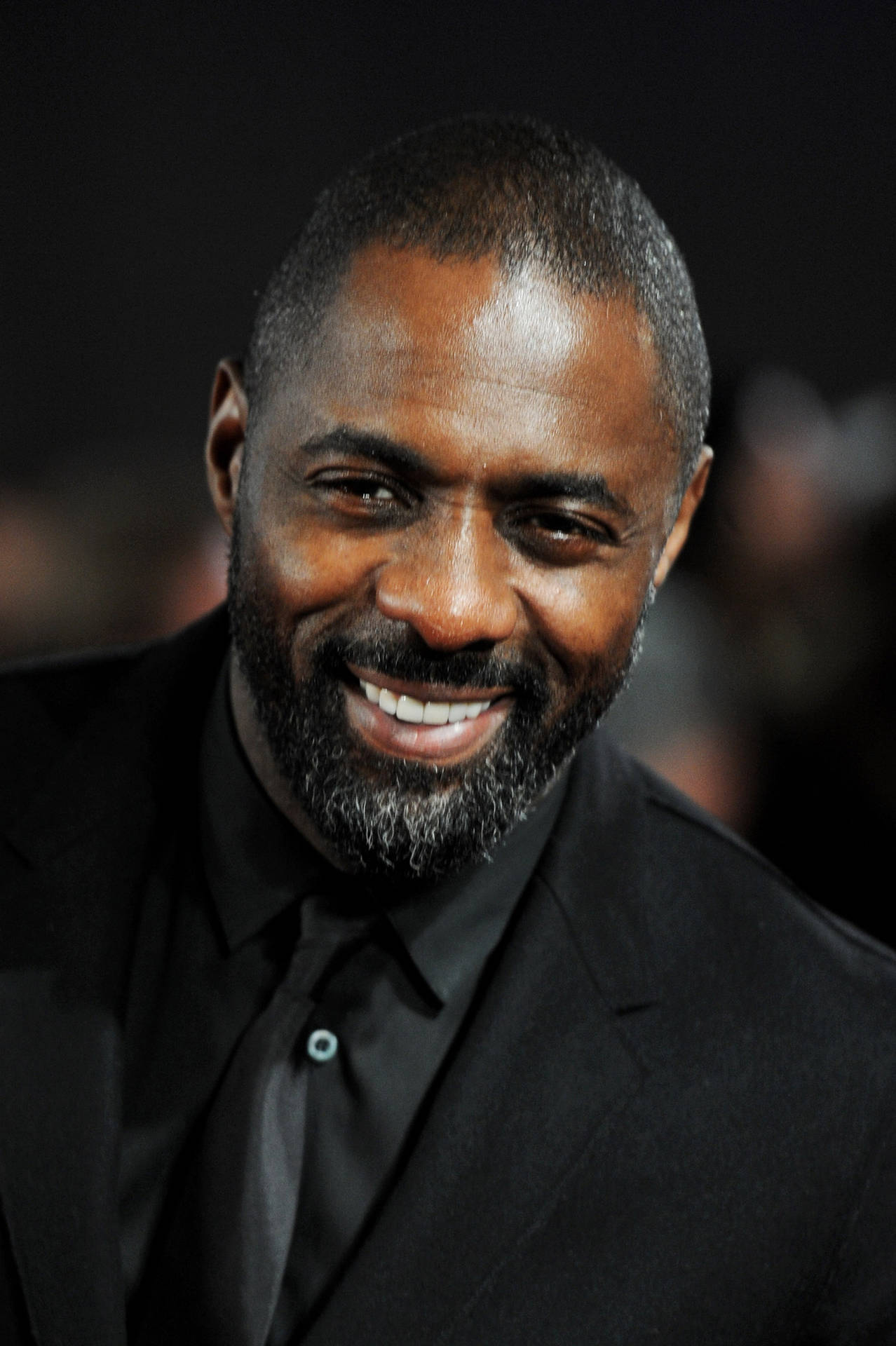 Idris Elba Against Blurry Dark Backdrop