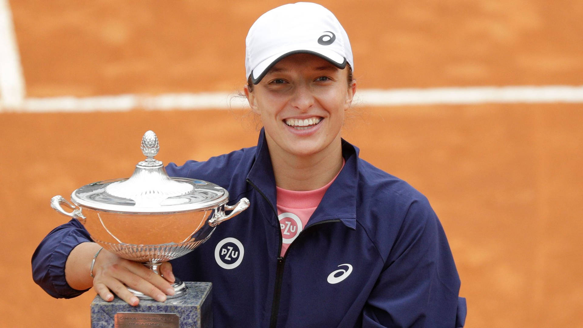 Iga Swiatek Holding Her Big Trophy Background