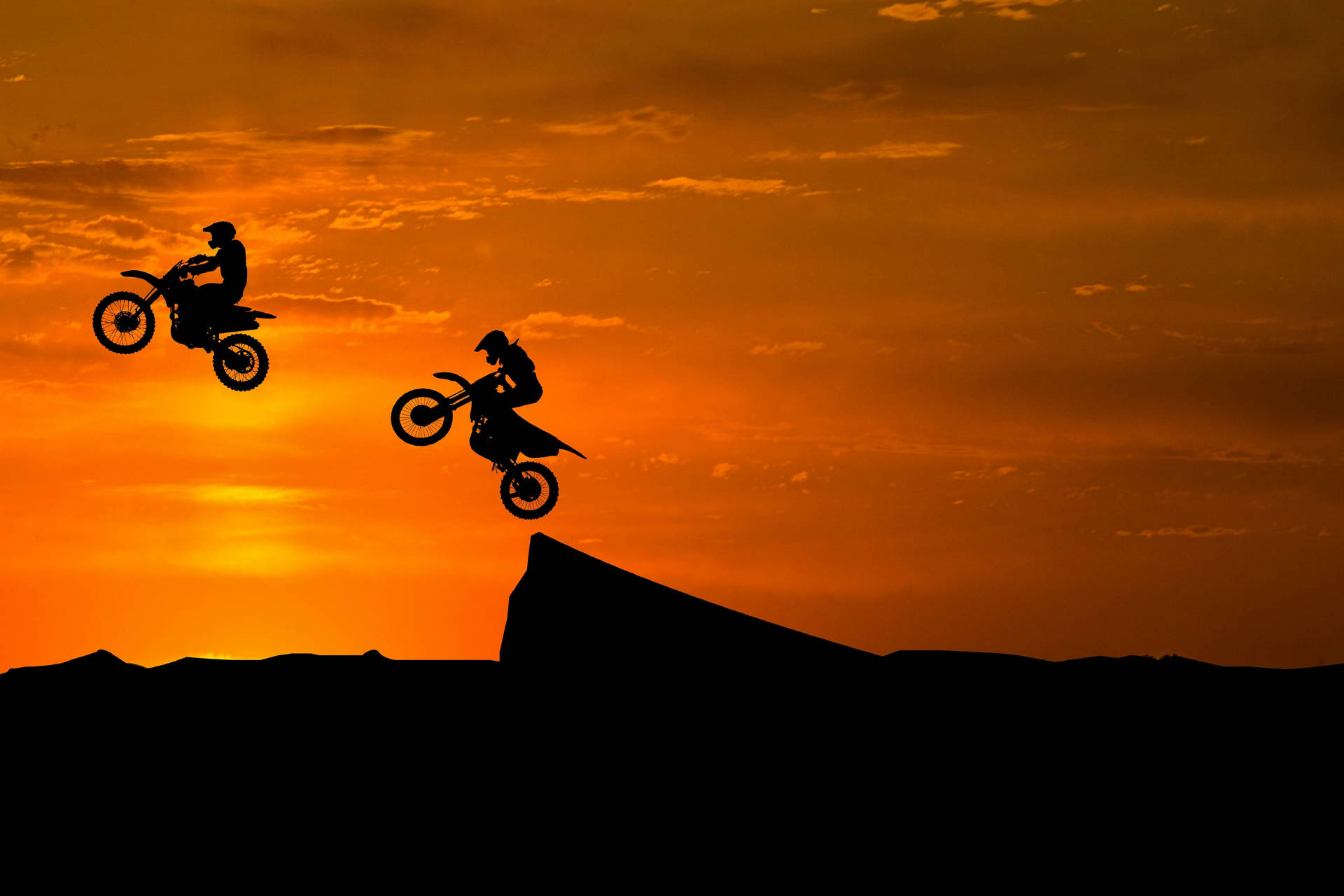 Igniting Passion – Extreme Sports Motocross Silhouette Background